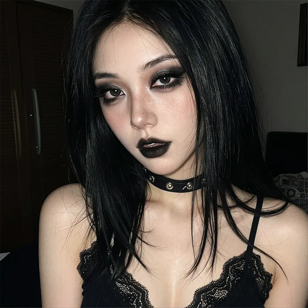 Round avatar of a fictional club regular with black hair and dark eye make-up